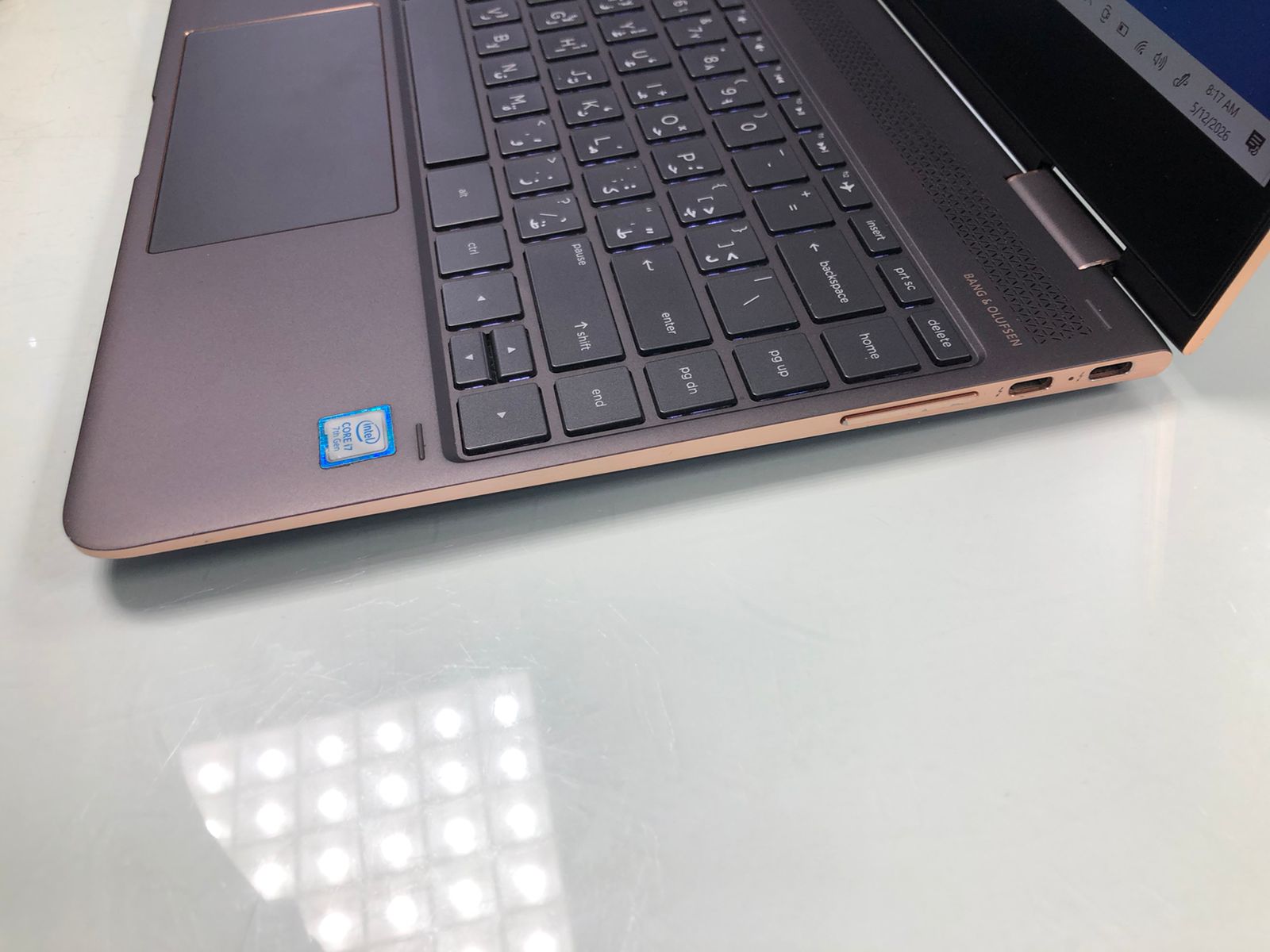 Laptop on a white surface with a blurred background