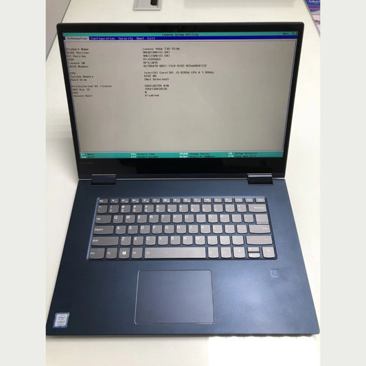 Laptop with a command line interface on the screen, placed on a white surface.